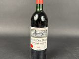 a bottle of red wine sitting on top of a table