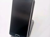 a cell phone that is sitting on top of a stand