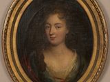 un tableau représentant une femme en robe verte, dans un cadre doré