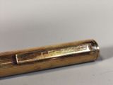 a close up of a pen on a white surface