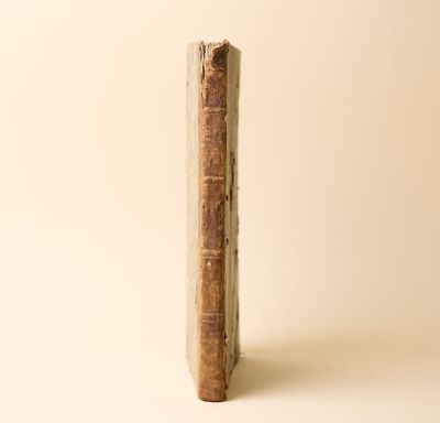 un vieux livre posé sur une surface blanche
