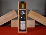 a bottle of wine in a wooden box on a table