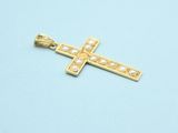 a close up of a gold cross on a blue surface