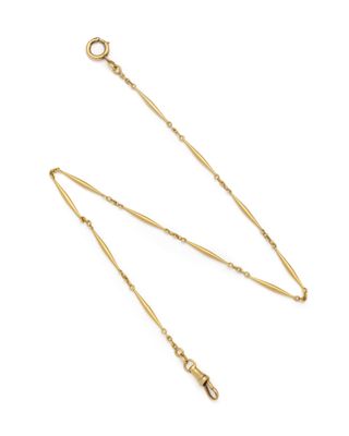 a gold plated necklace with a long chain on a white background