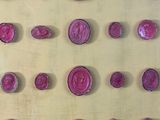 many wax seals that are on the wall of a room