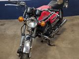 a red and black motorcycle parked in a garage