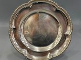 a silver plate with a decorative design on the rim
