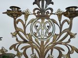 a metal candelab with a decorative design on it