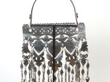 a silver purse with a chain hanging from it