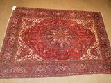 rug on the floor in a room with a chair and a table