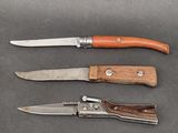 three different types of knives on a table with a knife in the middle