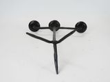 a black metal object that is on a white surface