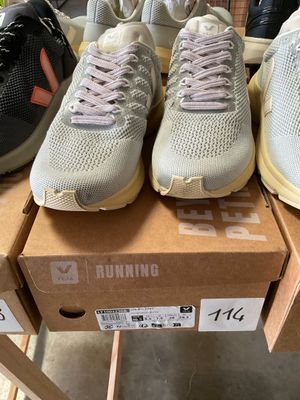 several pairs of running shoes are on display in a store