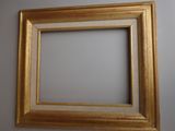 an old picture frame hanging on a wall in a room