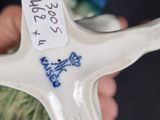 a white starfish with blue writing on it in a person ' s hand