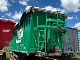 un wagon vert garé à côté d'un wagon rouge