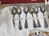 a box with a set of silver spoons and spoons in it