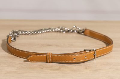 a close up of a brown belt with a chain on it