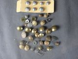 a lot of buttons that are sitting on a table