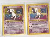 four pokemon cards are lined up in a row on a table