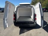 a white van with its doors open in a parking lot