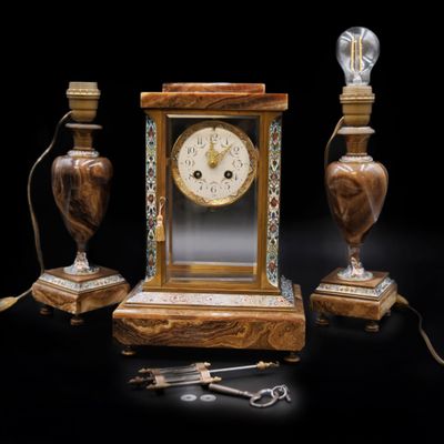 une horloge posée sur une table à côté de deux lampes