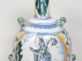 un vase sur lequel figure l'image d'un homme tenant un bâton