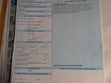 a lot of papers on a table with a calculator next to it