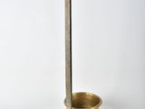 an old brass scale with a cup and a spoon on it