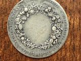 a close up of a silver coin on a wooden surface