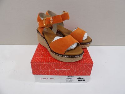 a pair of sandals on top of a red box