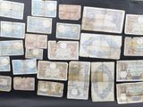 several different types of paper money are displayed on a black surface