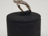 a close up of a diamond ring on a black box