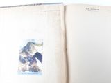 an open book with a picture of a mountain on it