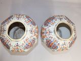 two vases that are sitting on a table