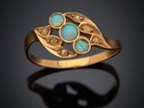a gold ring with oplite and pearls