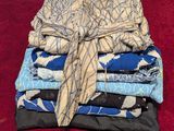 a stack of folded cloths on a red surface
