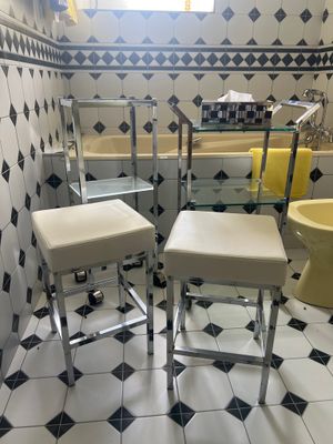 deux tabourets dans une salle de bains équipée d'un lavabo et d'une baignoire