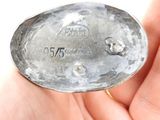someone is holding a silver spoon in their hand and it is very old