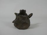 a small bronze sculpture of a horse head on a white surface