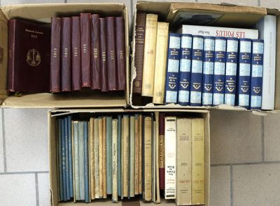 many books that are in a box on the floor