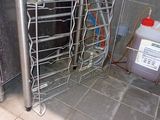 a metal rack that has a lot of bottles in it