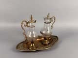 pair of silver plated teapots on tray on white background