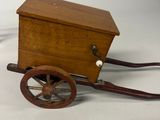 a small wooden cart with a wooden box on top of it
