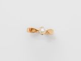 an image of a gold ring with a pearl in the center