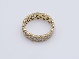 a close up of a gold and diamond ring on a white surface