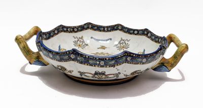 a blue and white bowl with handles on a white surface