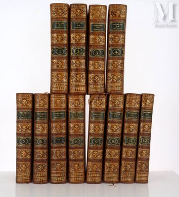 a stack of old books sitting on top of a white table
