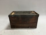 an old wooden box with a metal lid on a white background