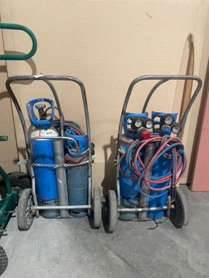 two carts with gas bottles and hoses on them